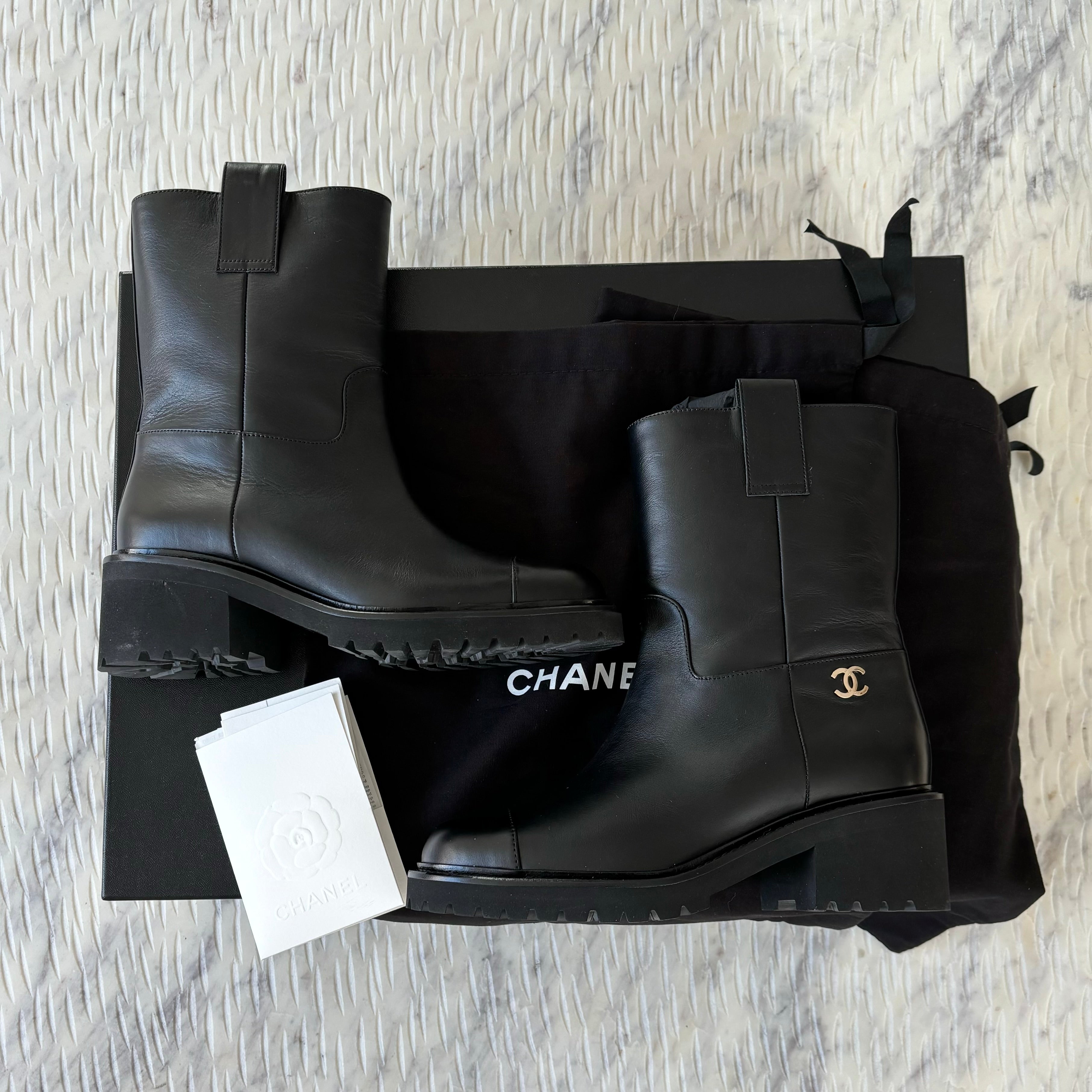 Chanel leather moto boots with CC logo.