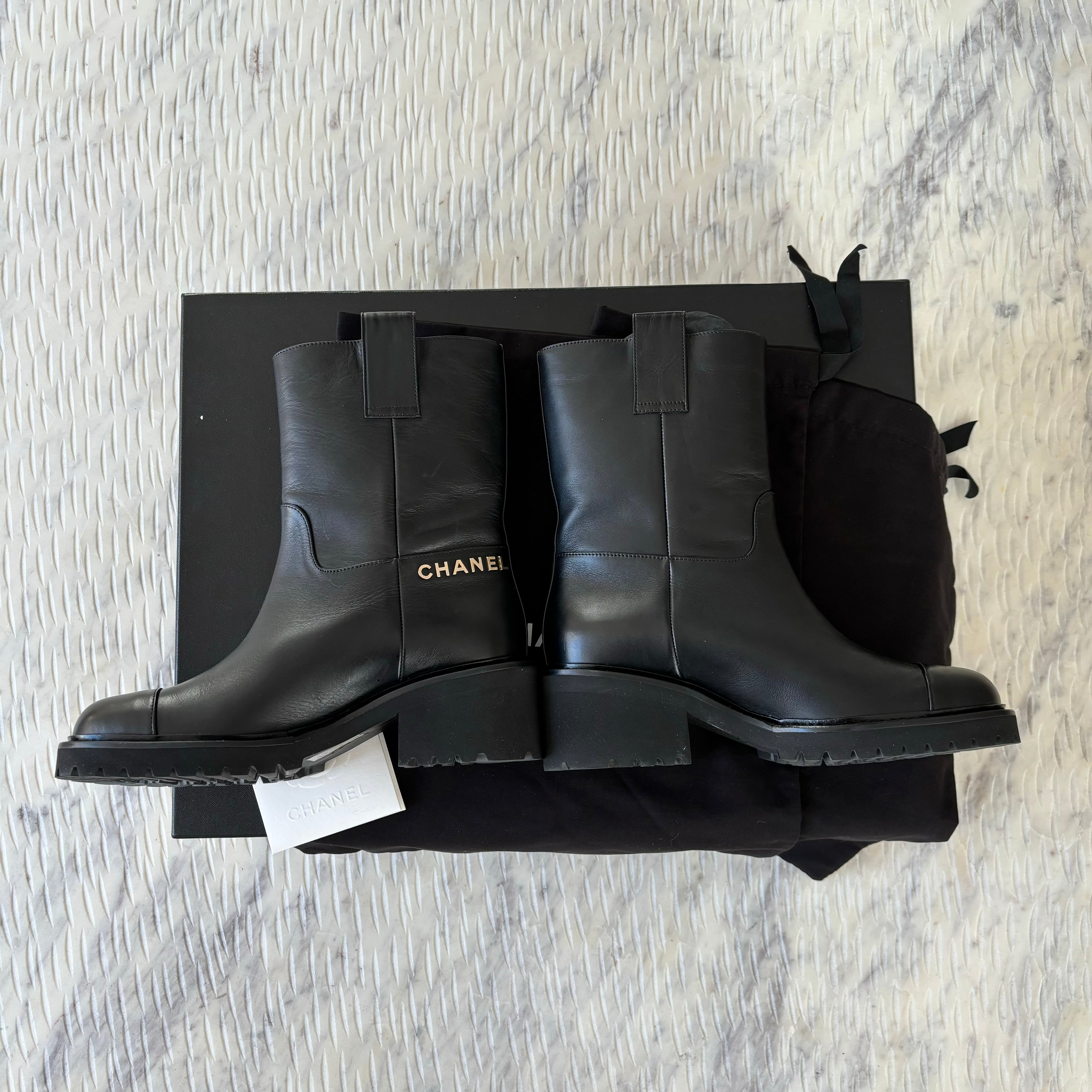 Chanel leather moto boots with CC logo.