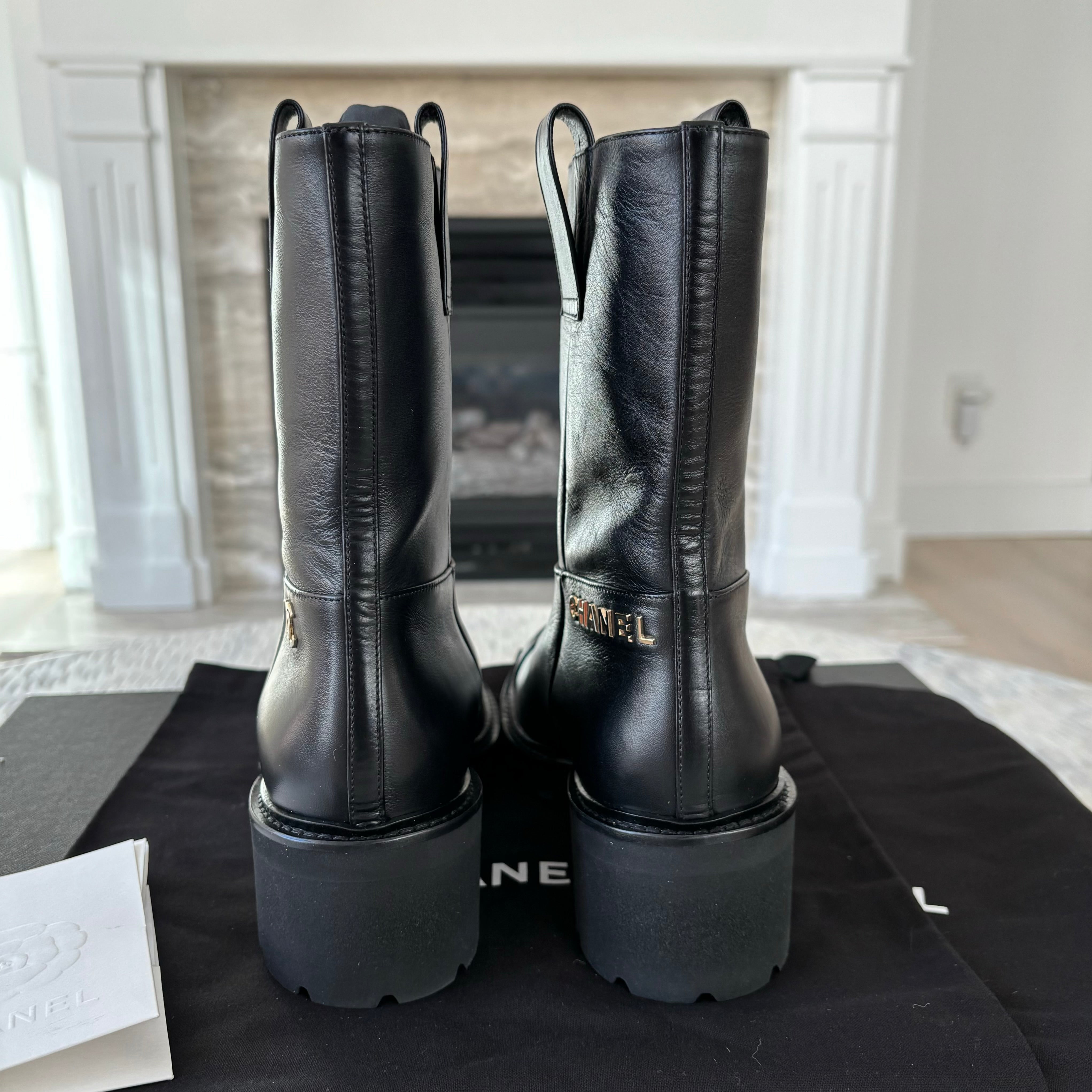 Chanel leather moto boots with CC logo.