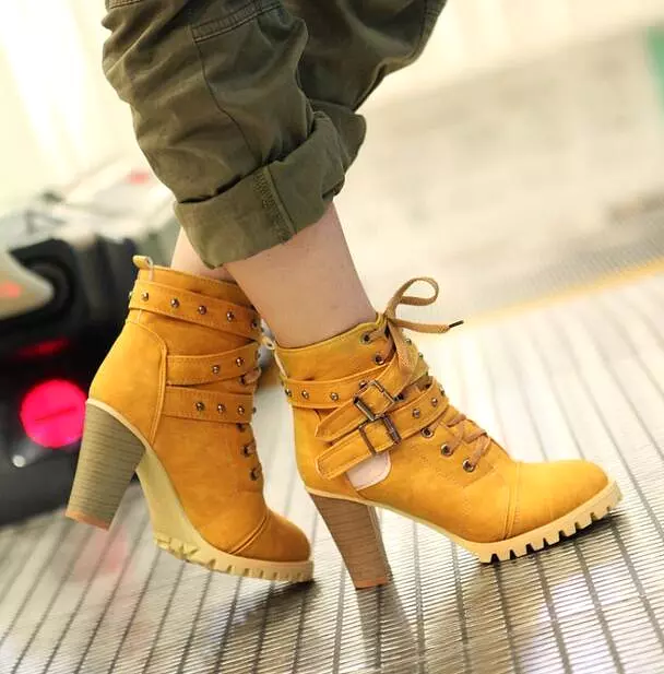 Punk lace-up buckle strap ankle boots for women with block heel and retro belt design.