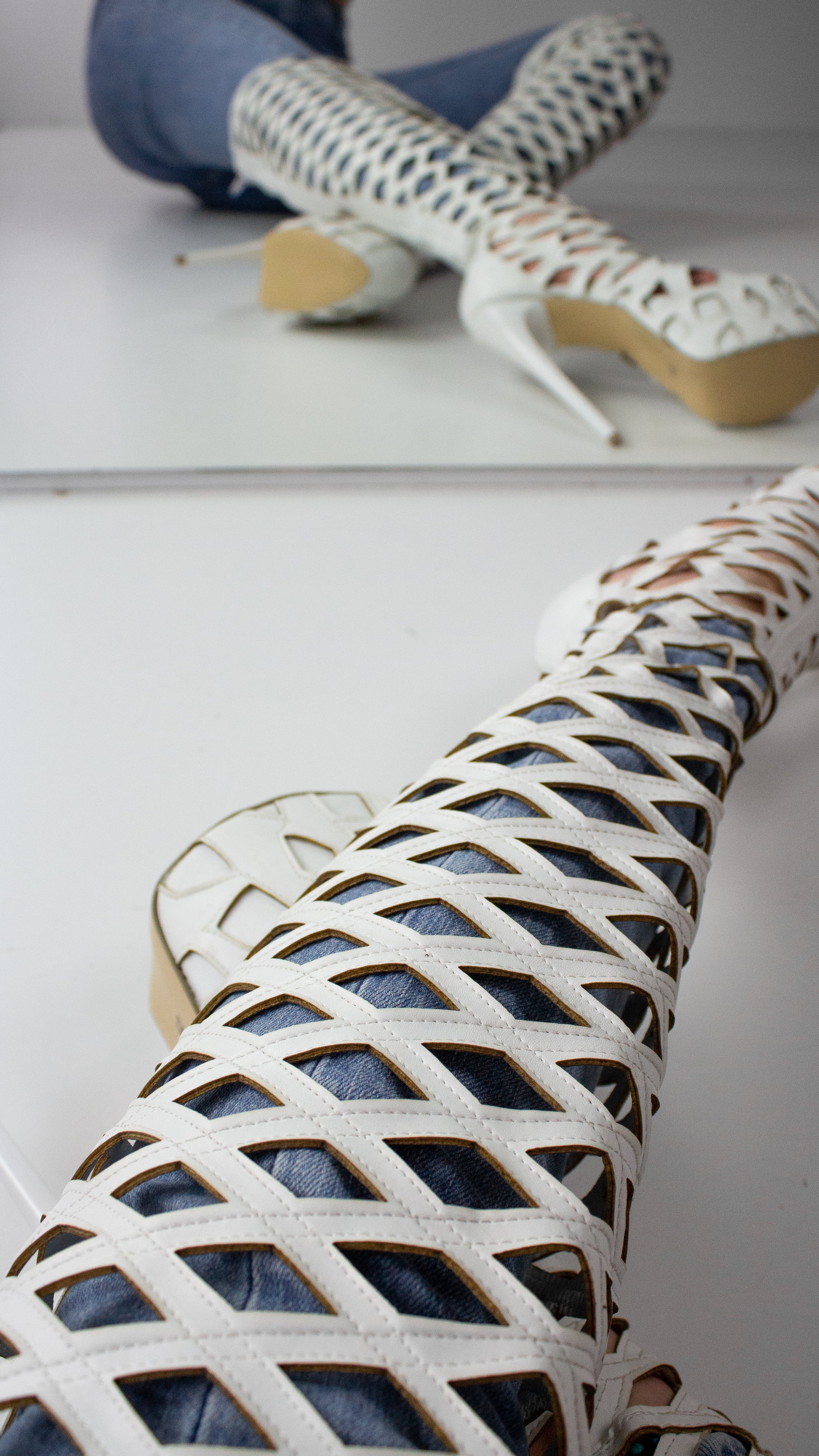 White laser-cut knee-high boots