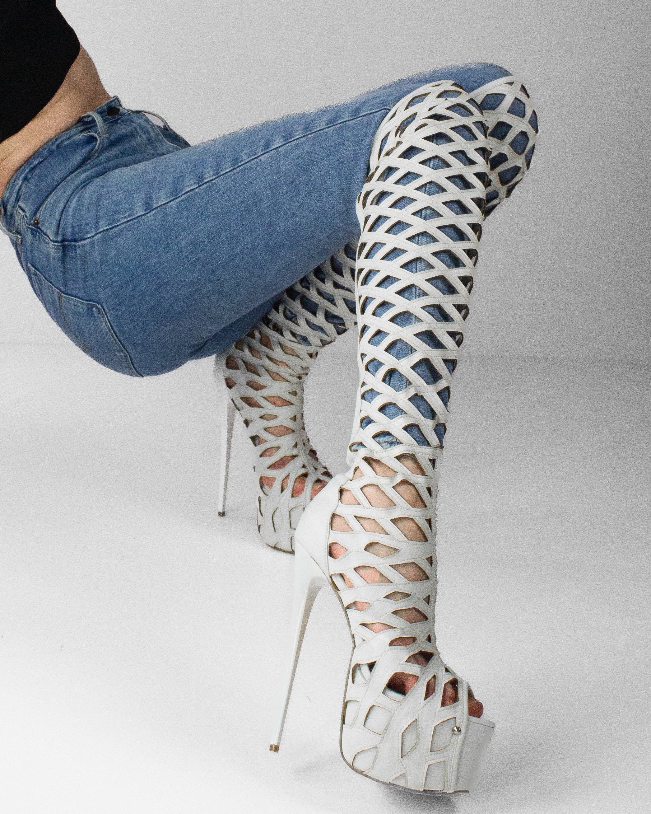 White laser-cut knee-high boots