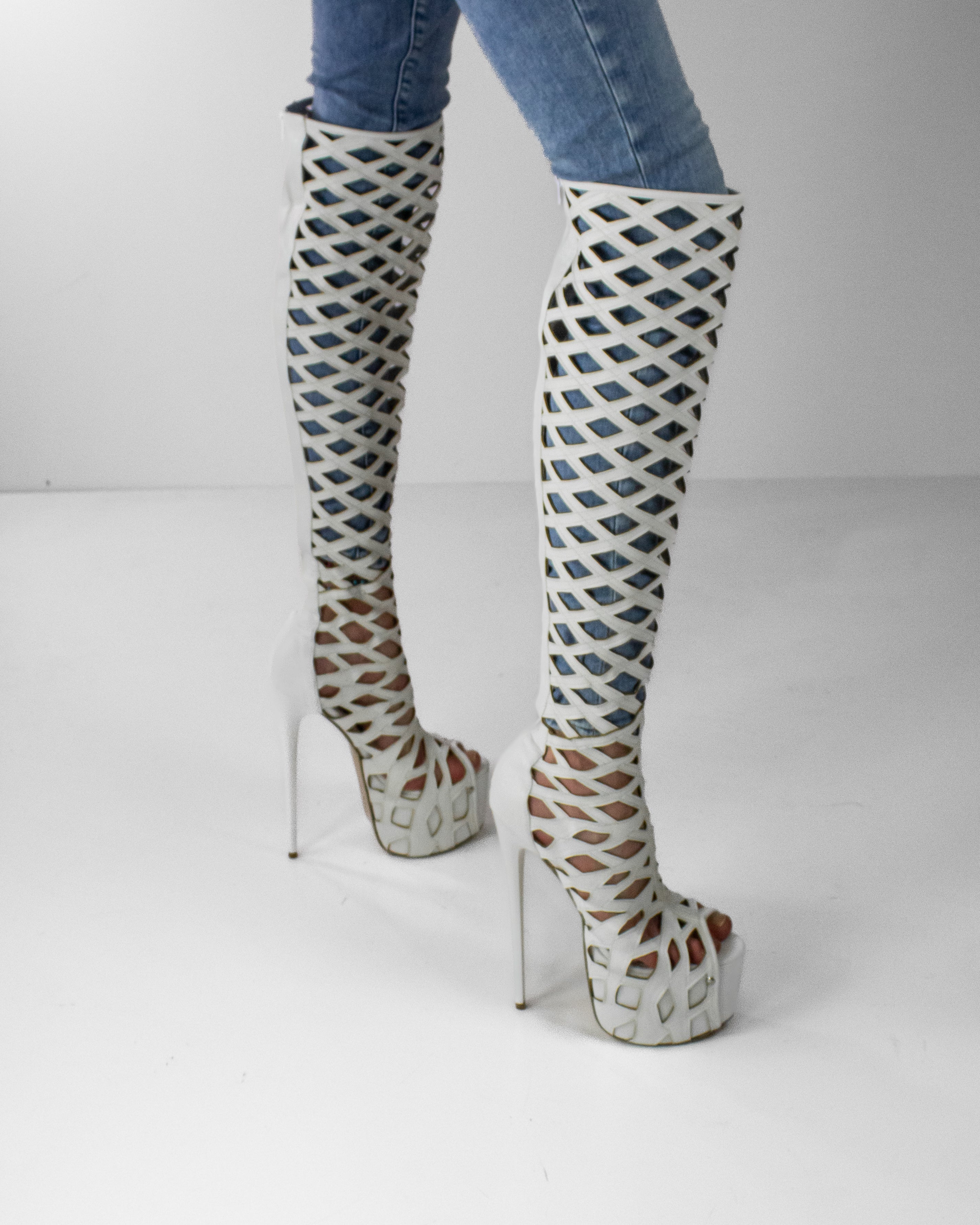 White laser-cut knee-high boots